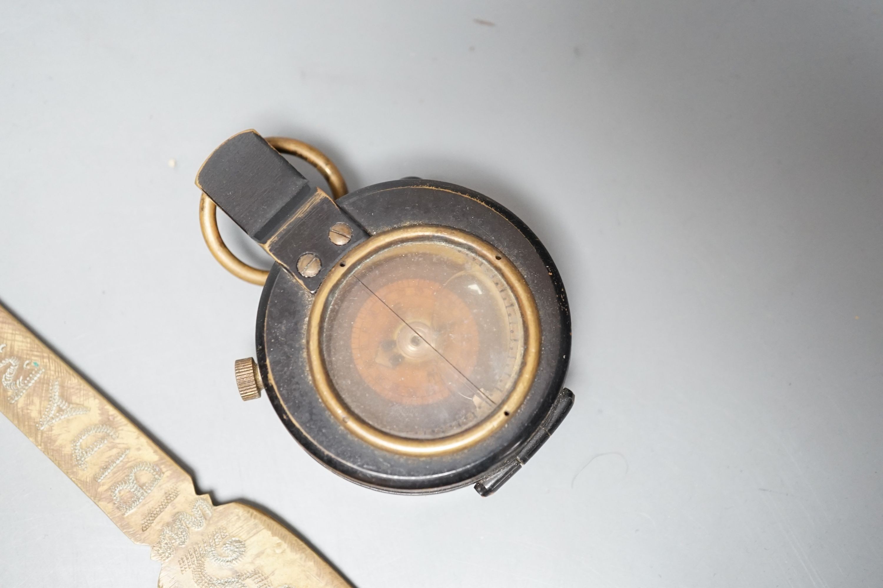 An Eastern dagger, in sheath, leather collars box, cased early 20th century Dollond compass and three others